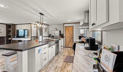 Kitchen with white cabinetry, a kitchen island wit