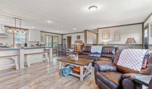 Living room featuring crown molding, light wood-st