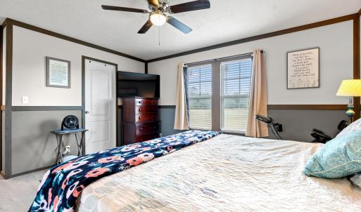 Bedroom with a textured ceiling, carpet floors, ce