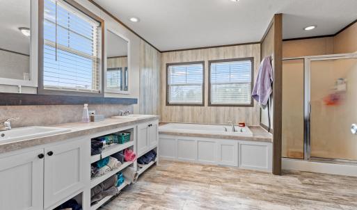 Full bathroom featuring a shower stall, a bath, do