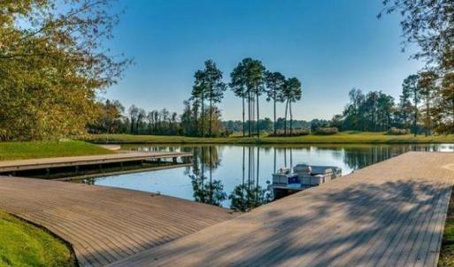 Dock featuring a water view and view of wooded are