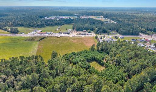 Aerial view of property's location with a forest