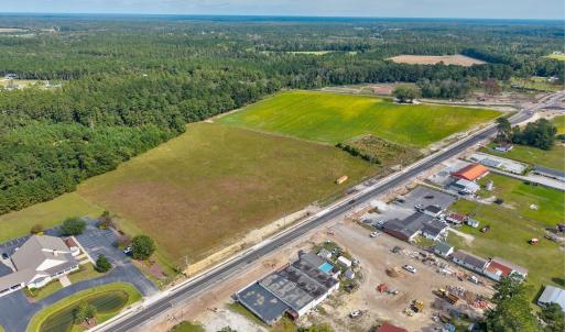 View of property location with a heavily wooded ar