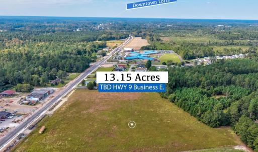 View of property location with a heavily wooded ar
