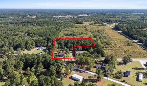 View of property location with a forest and proper