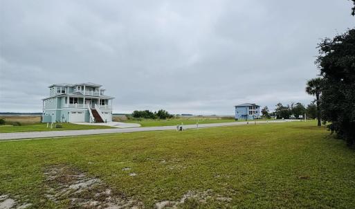 View of home's community with a yard