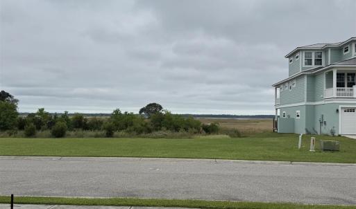View of asphalt road featuring sidewalks