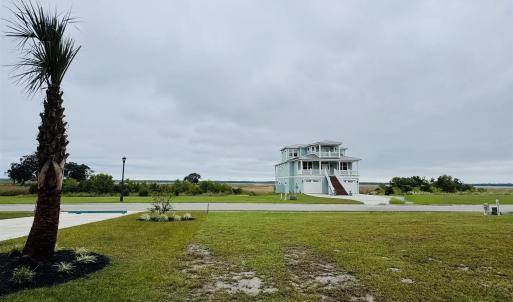View of community featuring a yard and stairway