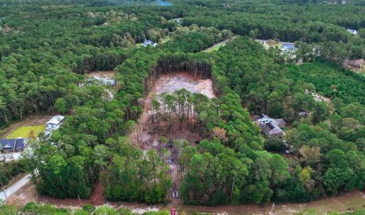 View of property location with a heavily wooded ar