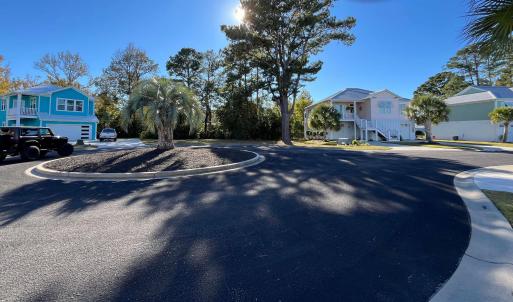 View of asphalt street featuring stairway, curbs,