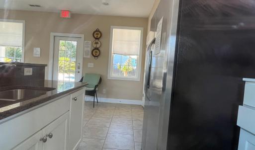 Club house Kitchen featuring stainless steel refri