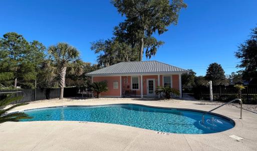Community pool featuring a patio and an outdoor st