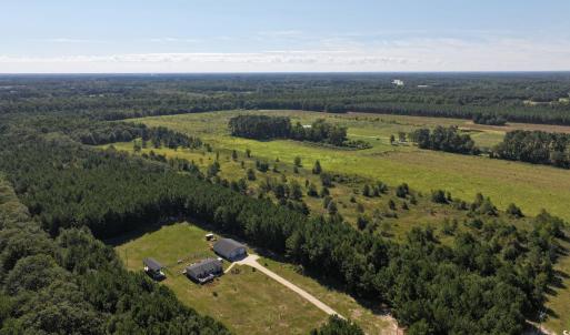 Aerial view of property's location with a forest