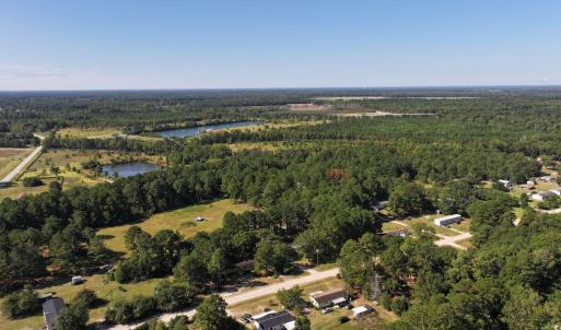 Aerial view of property's location with a forest a