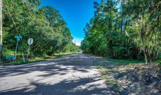 View of asphalt road featuring traffic signs
