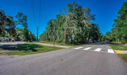 View of asphalt road featuring traffic signs and v