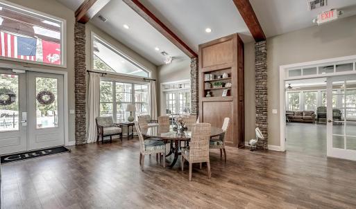 Living room with dark wood-type flooring, high vau