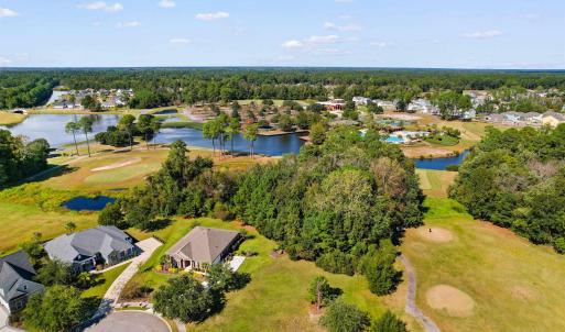 Aerial view of residential area featuring a golf c