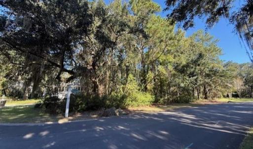 View of asphalt road with a view of trees