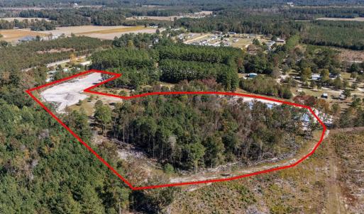 Aerial view of property's location with a forest a