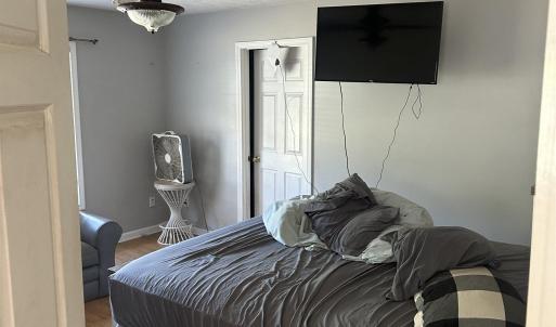 Bedroom featuring a textured ceiling, wood finishe
