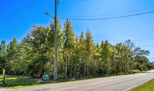 View of asphalt road with street lighting