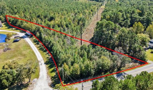 View of property location featuring a forest and p