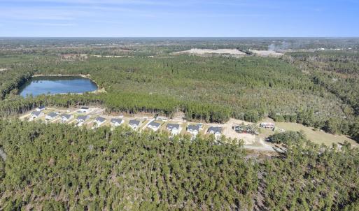 Aerial view of property's location with a forest a