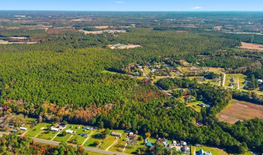 View of property location with a heavily wooded ar