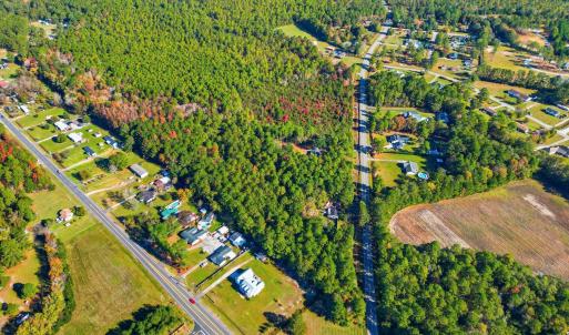 Aerial view of property's location with a forest