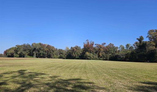 View of green lawn featuring a view of rural / pas