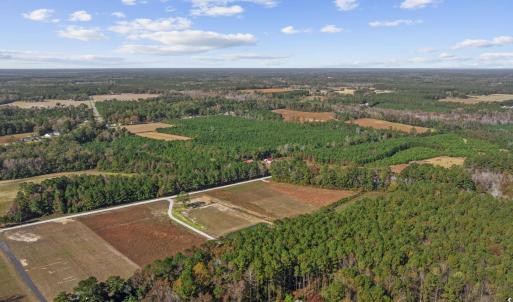 Aerial view of property's location with a forest