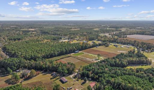 View of property location with a heavily wooded ar