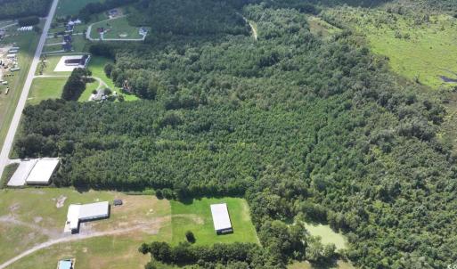 View of property location with a heavily wooded ar
