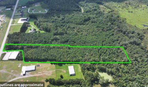 View of property location with a heavily wooded ar