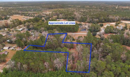 Aerial view of property and surrounding area with