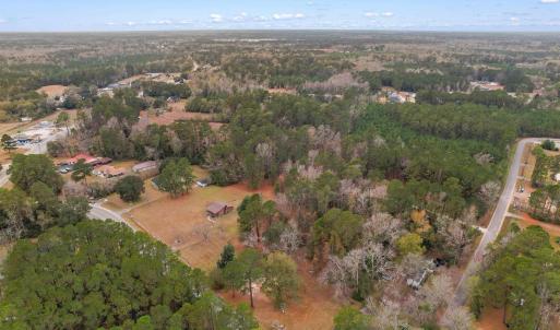 Aerial view of property's location with a forest