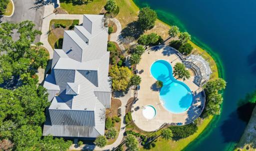 Drone / aerial view of a pool and a large body of