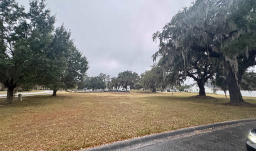 View of property's community featuring a lawn