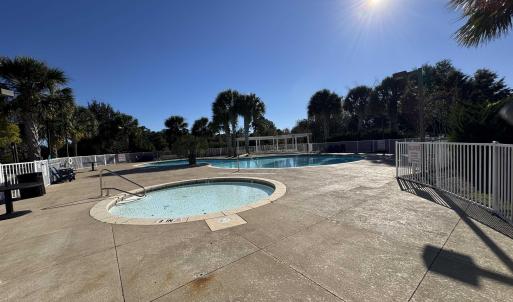Community pool featuring a patio and a community h