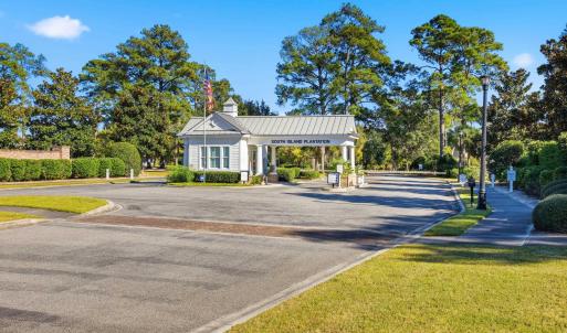 View of asphalt road featuring sidewalks, curbs, a