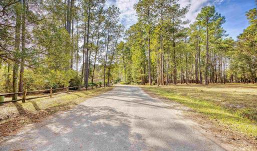 View of asphalt road with a view of trees