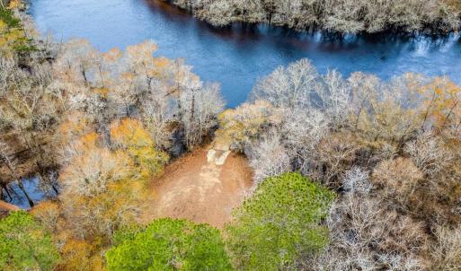 Aerial view of a nearby body of water and a heavil