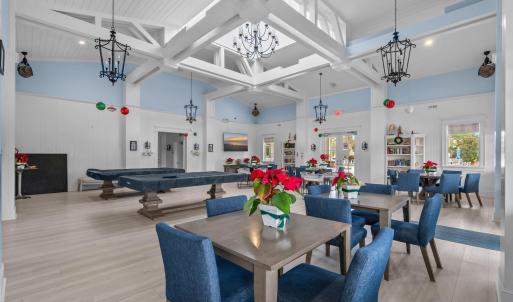 Dining area with wood finished floors, a high ceil
