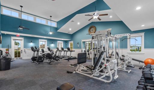 Workout area with a wainscoted wall, a ceiling fan