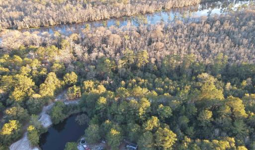 Aerial view of property's location with a forest a