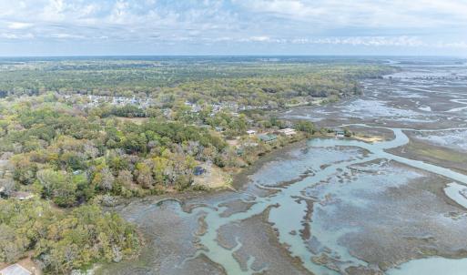 View of property location with a heavily wooded ar