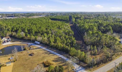 Aerial view of property's location with a forest
