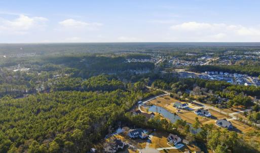 View of property location with a heavily wooded ar