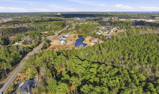 View of property location featuring a forest